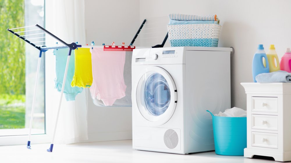 hanging laundry and washing machine in a wash room