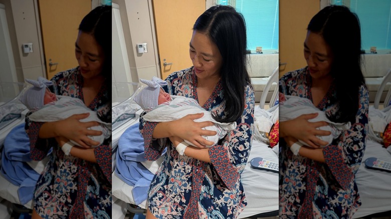Michelle Kwan holding baby Della Rose Kwan in hospital