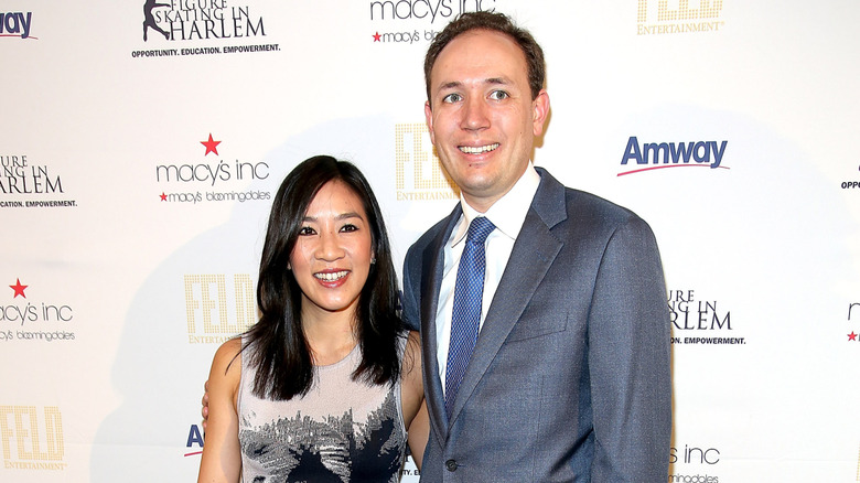 Michelle Kwan and Clay Pell posing on step-and-repeat