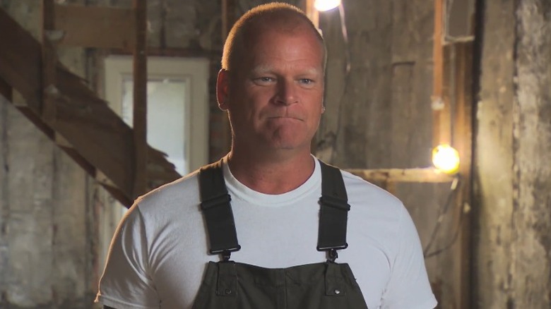 Mike Holmes standing in construction site during interview on his show