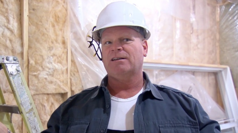 Mike Holmes wearing a hardhat in construction site