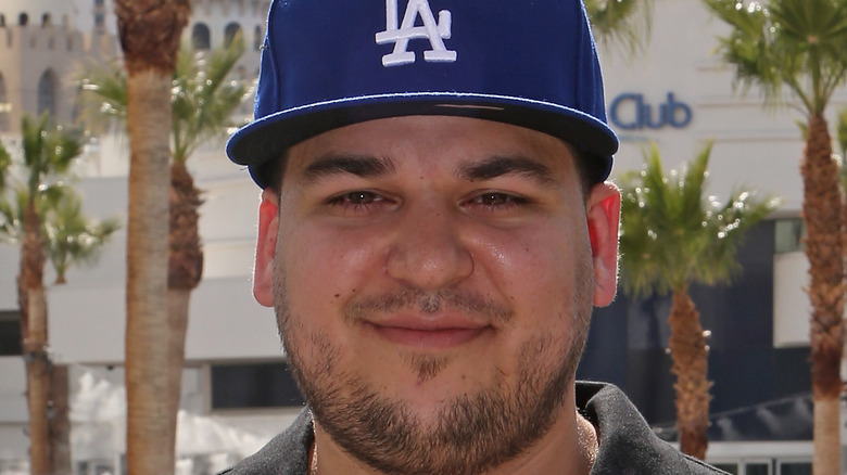 Rob Kardashian poses at an event