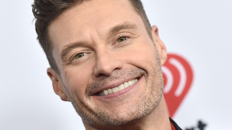 Ryan Seacrest smiles on a Capital One Red Carpet