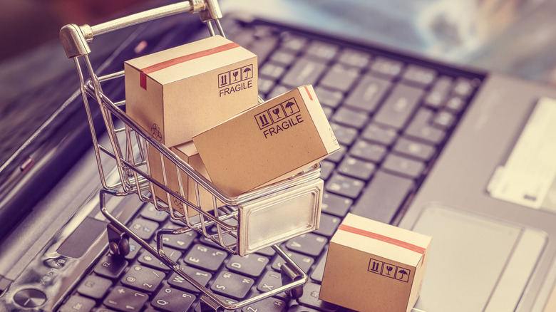 online shopping boxes in shopping cart on a laptop computer keyboard