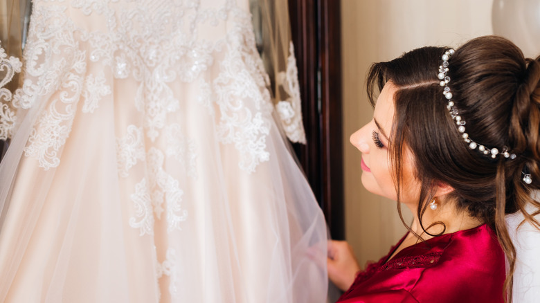 bride looking at wedding dress