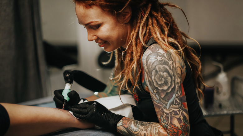 Female tattoo artist at work