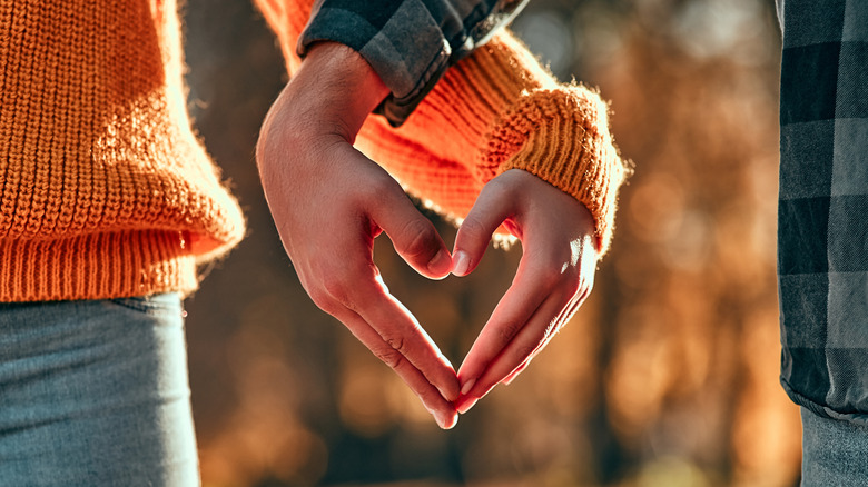 couple holding hands love heart