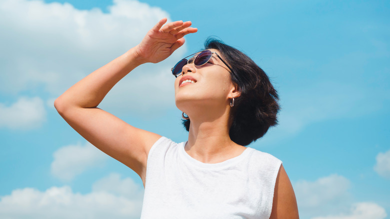 Woman posing with sky behind her 