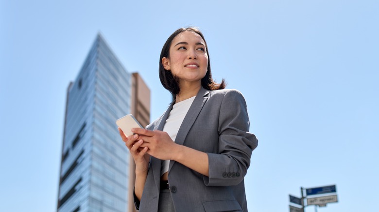 professional young woman holding phone