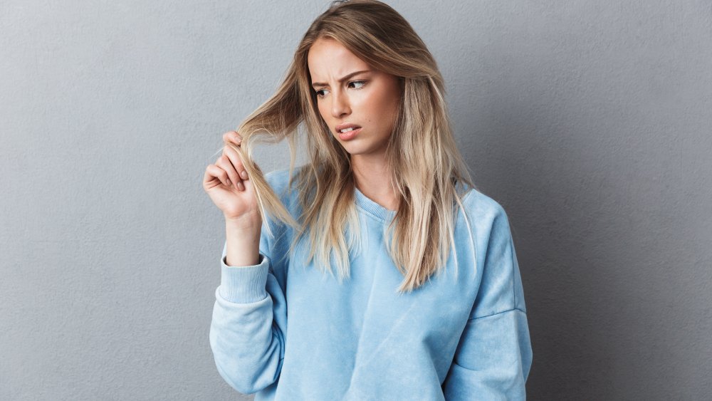 Woman looking at her hair