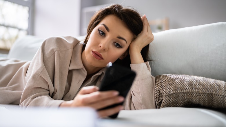 woman scrolling through phone
