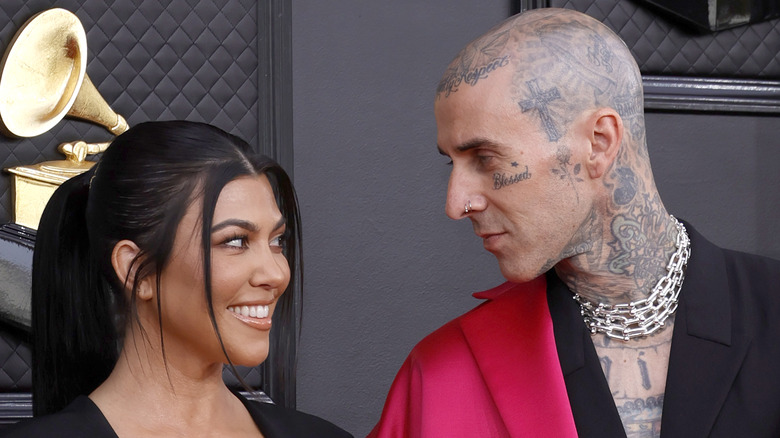 Kourtney Kardashian and Travis Barker look longingly at each other