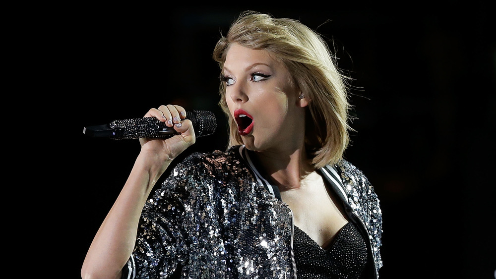 Taylor Swift singing into a microphone