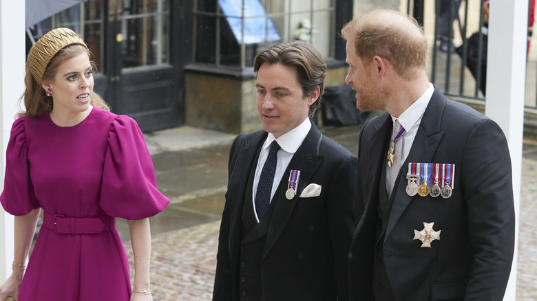 Princess Eugenie in a magenta dress alongside Edoardo Mozzi and Prince Harry as walk to King Charles III's coronation