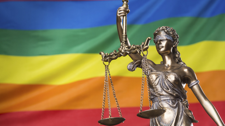 The scales of justice over a pride flag