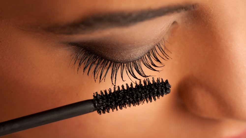 Woman applying mascara