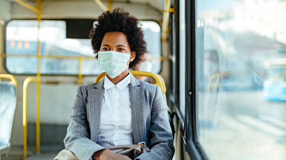 Woman wearing mask on bus