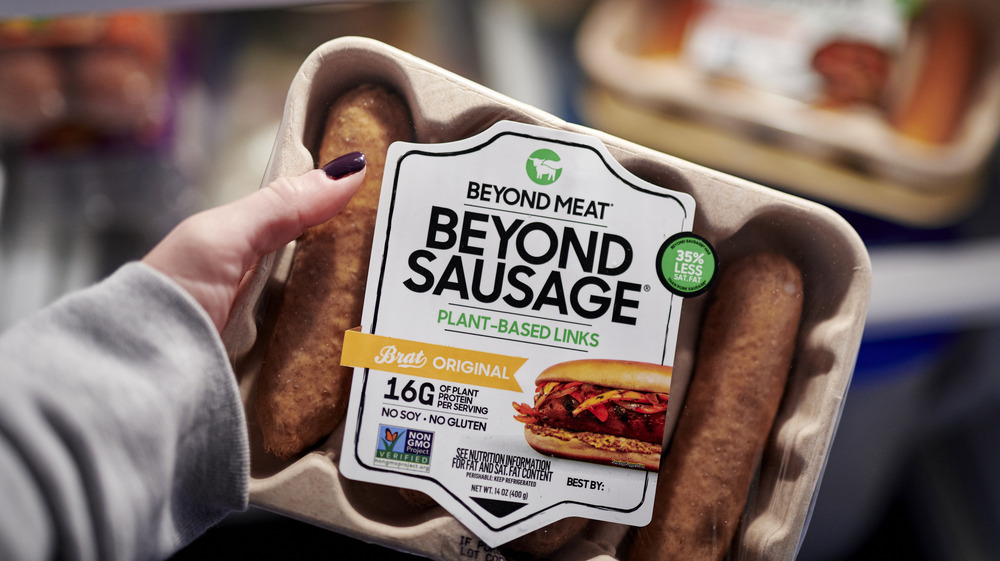 Woman holding Beyond Meat sausages
