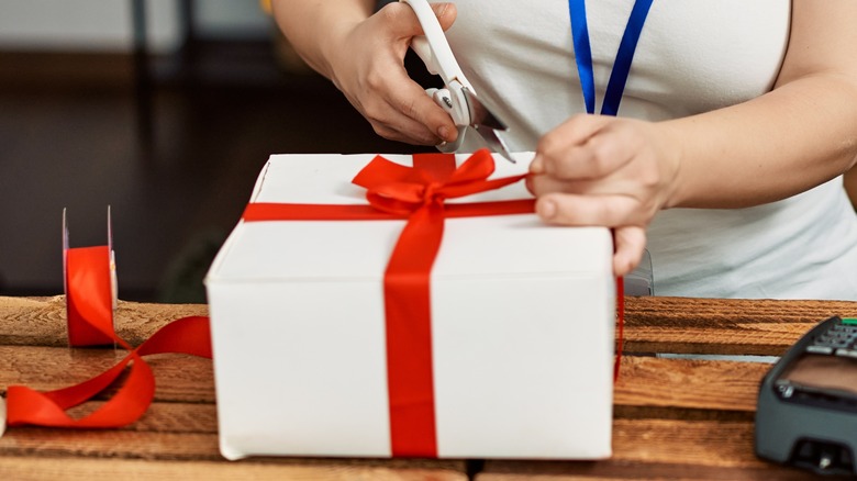 a woman wrapping a gift