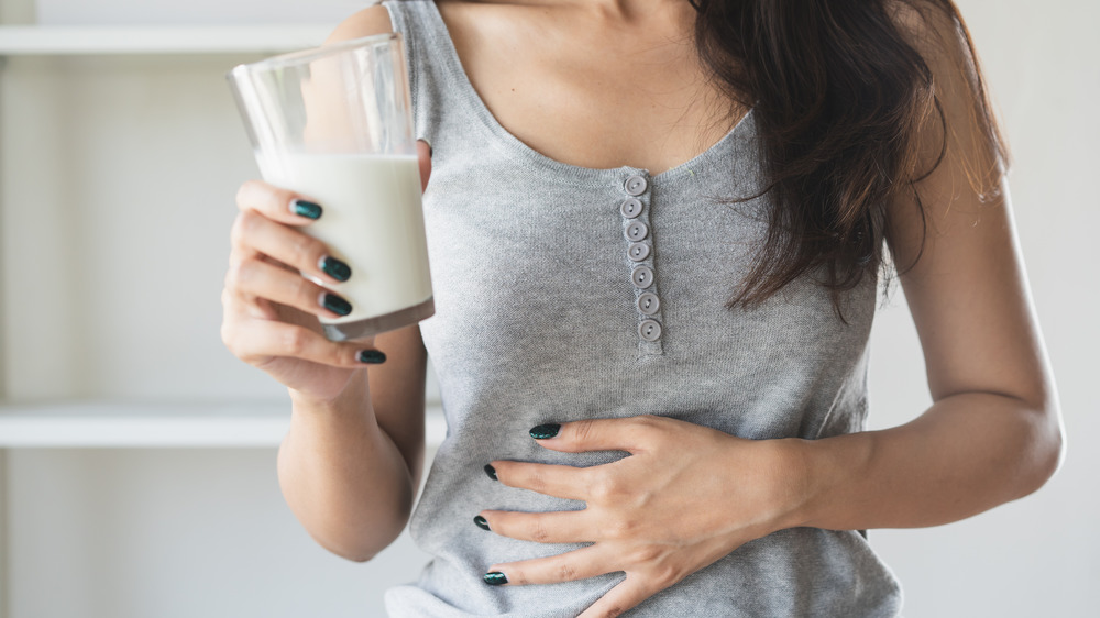 Woman drinking milk with stomachache