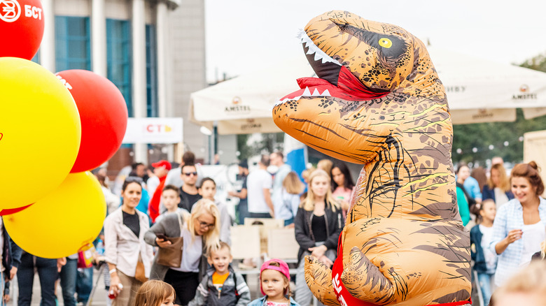 Person in inflatable dinosaur costume