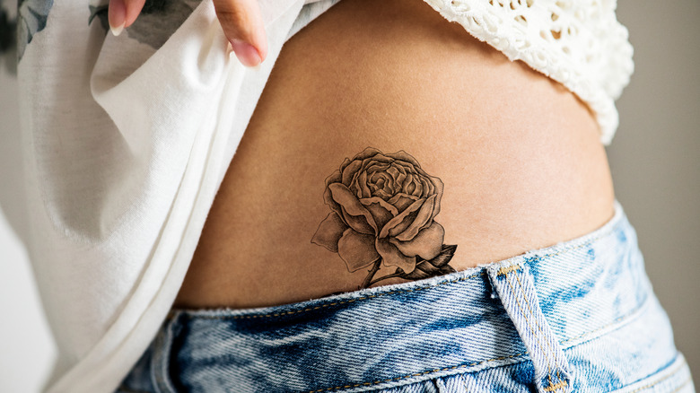 rose tattoo on torso