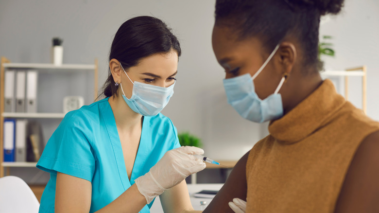 Woman getting COVID vaccine