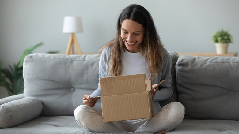 Woman opening parcel