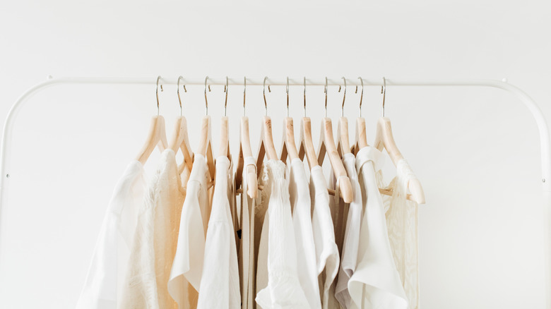 white outfits on garment rack 