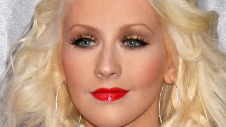 Christina Aguilera smiling in red lipstick