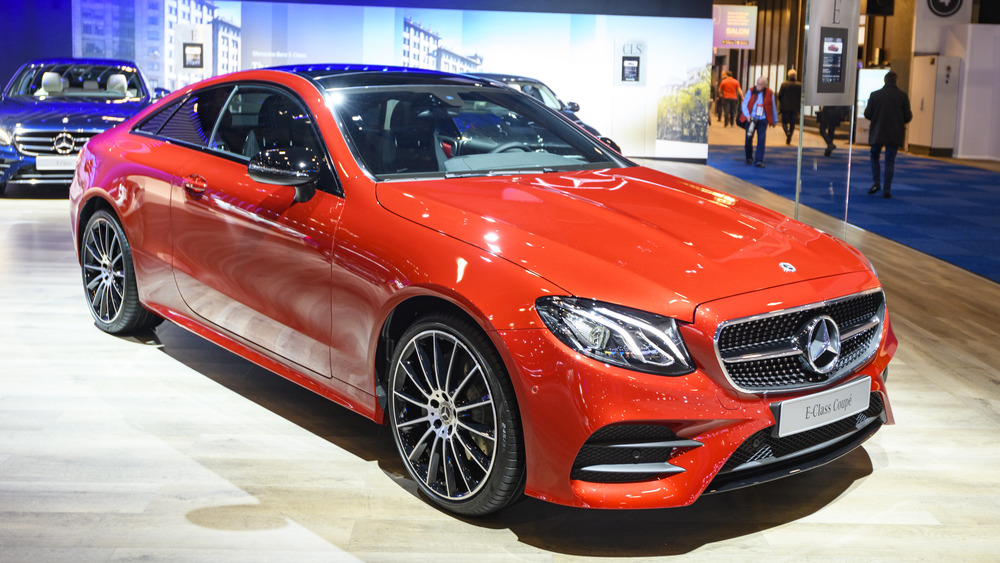 A red Mercedes-Benz E-class is seen at a car show.