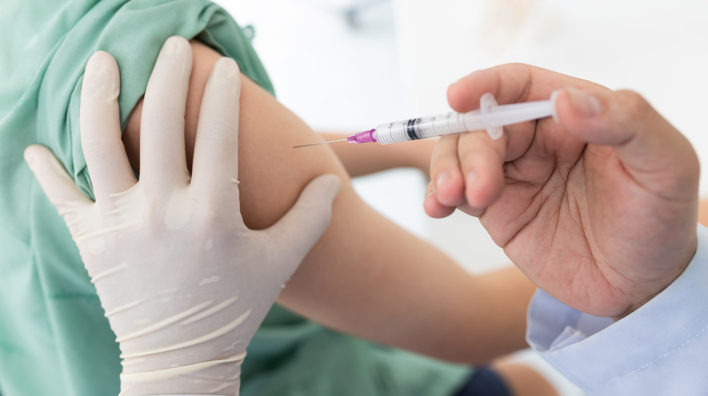 doctor administering vaccine