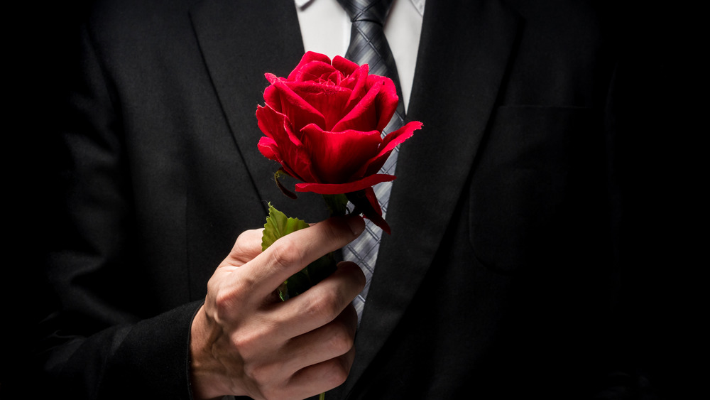 Bachelor holding rose
