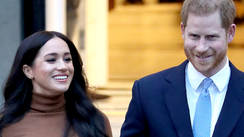 Meghan Markle and Prince Harry hold hands