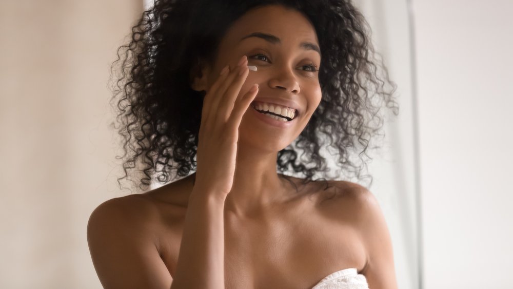 Woman applying eye cream