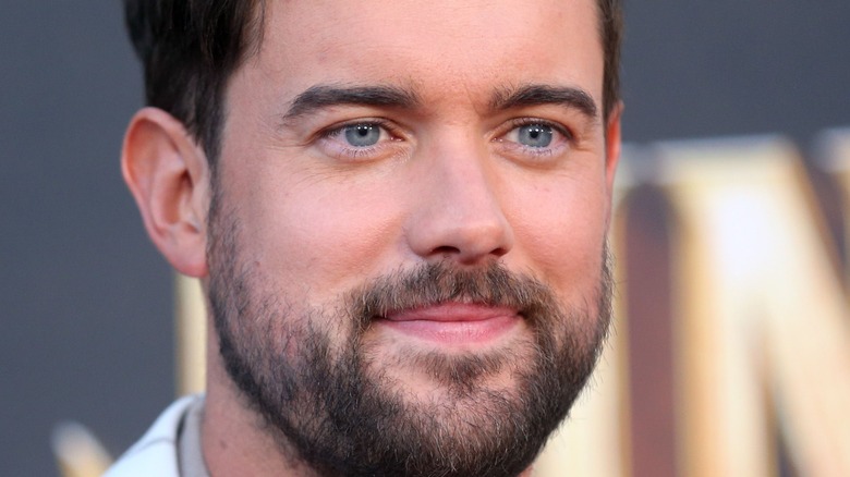 Jack Whitehall sports a beard and smiles.