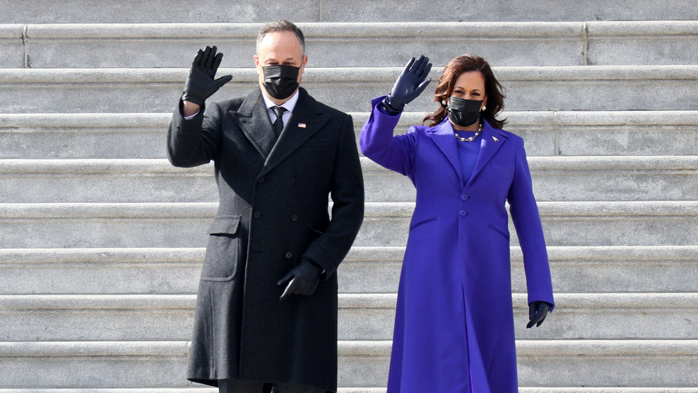 Kamala Harris and Doug Emhoff waving in masks