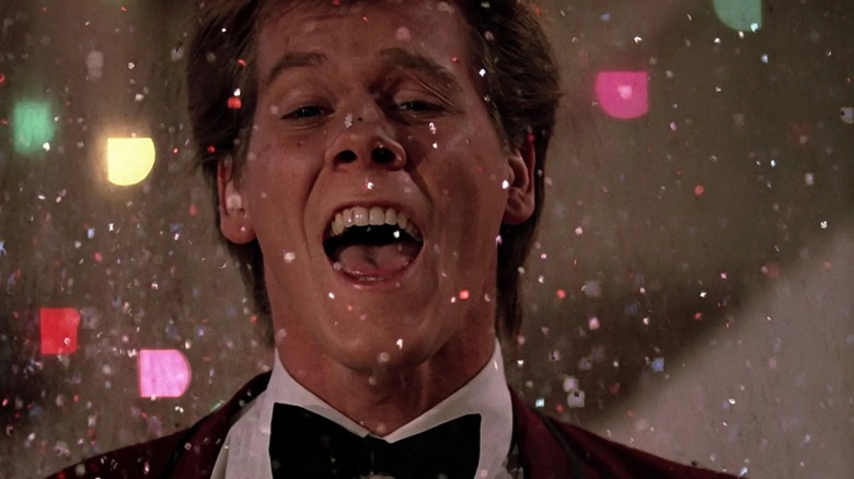 Kevin Bacon singing among an explosion of glitter in Footloose