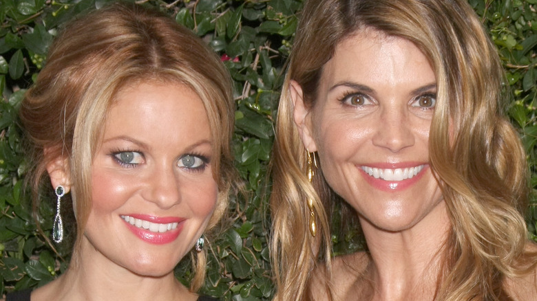 Candace Cameron Bure and Lori Loughlin in front of hedge