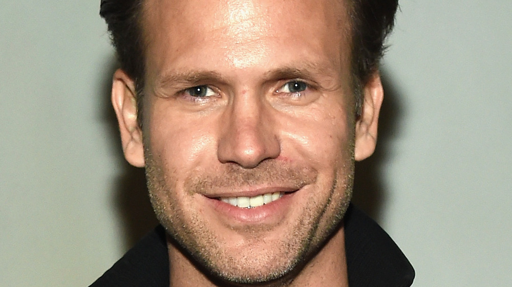 Matthew Davis smiling with facial scruff