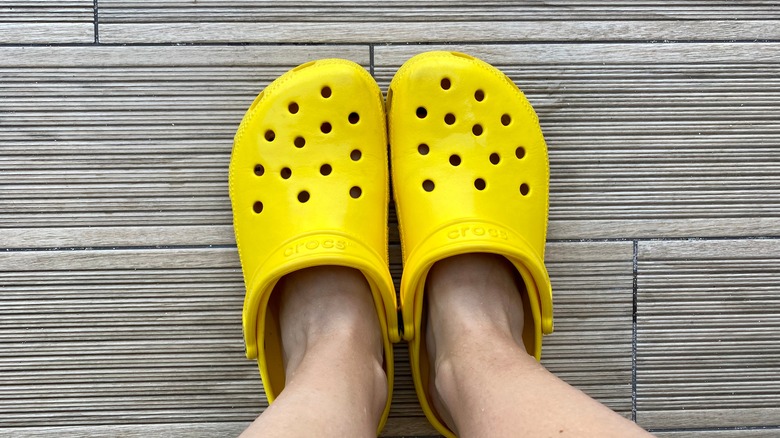 Feet in yellow Crocs