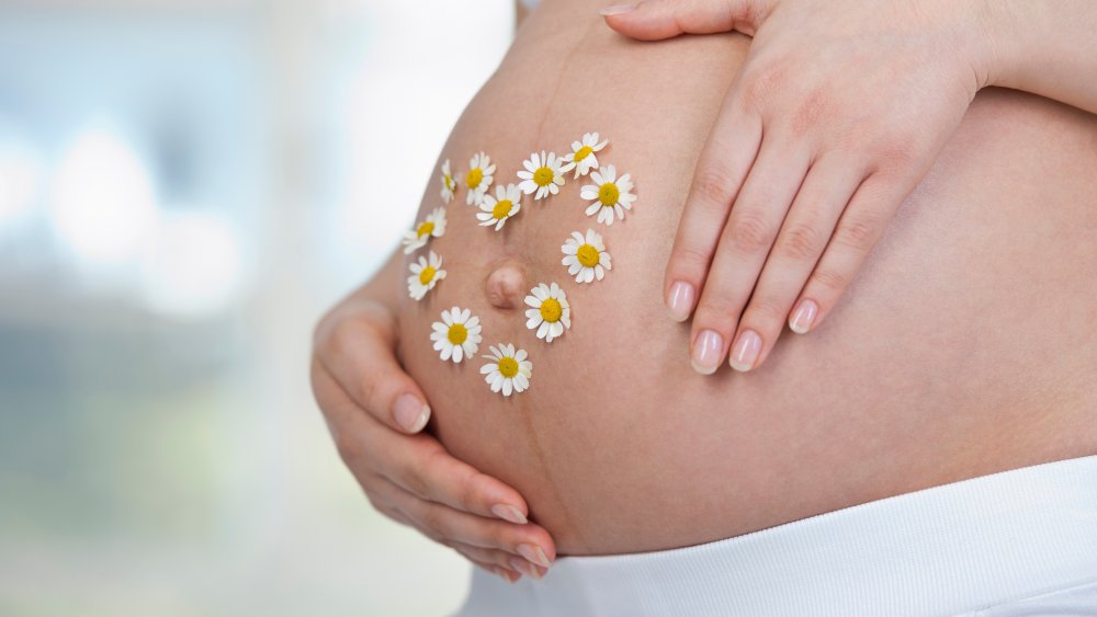 Pregnant belly with flowers on it