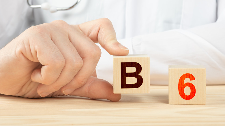 Doctor holding vitamin B6 signs