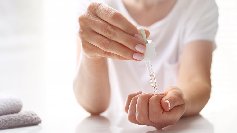 Woman using cuticle oil