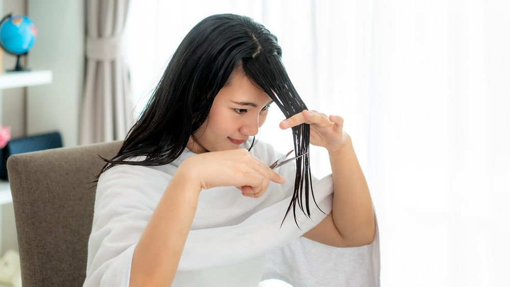 Woman cutting her bangs