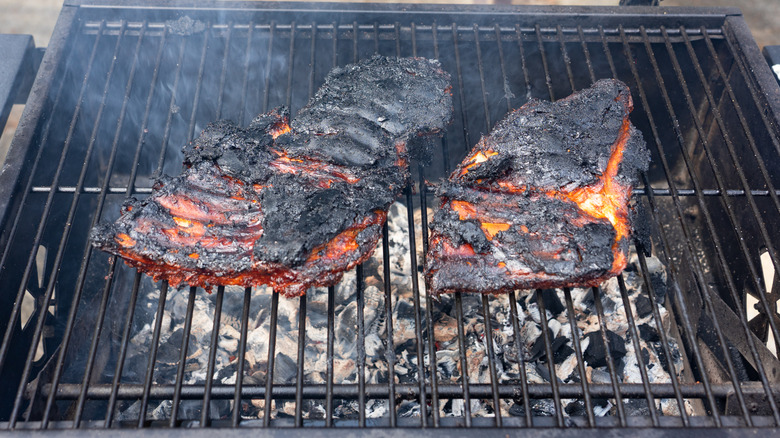 Burnt BBQ ribs on a grill