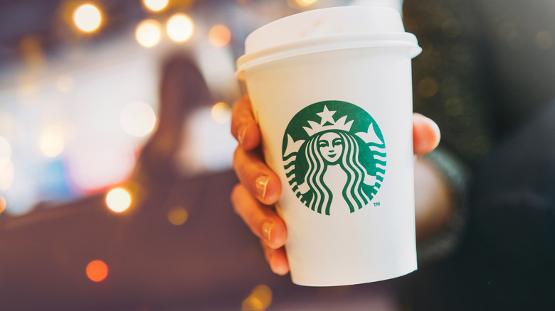 Person holding Starbucks cup