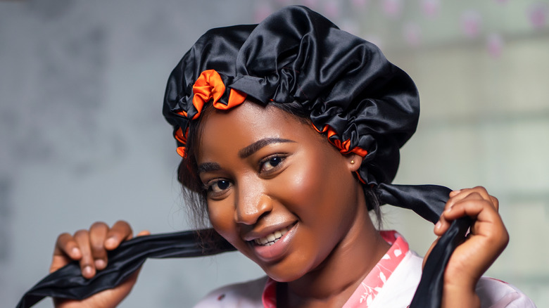 Woman preparing her bonnet for sleep