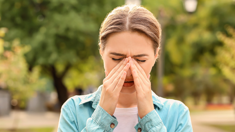 woman sneezing