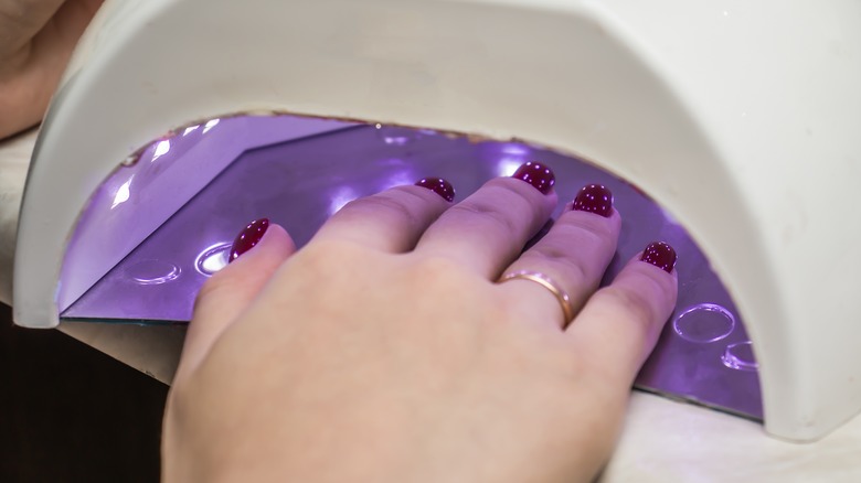 A woman's nails under a UV lamp